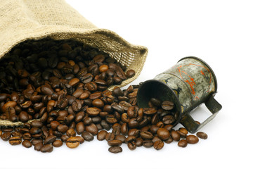 measuring cup  and a burlap bag with coffee beans on a white bac