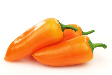 fresh orange peppers (capsicum) on a white background