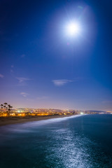 A full moon over the Pacific Ocean at night, seen from Balboa Pi