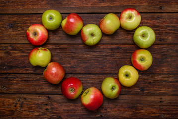 heart from fresh apples on wooden table