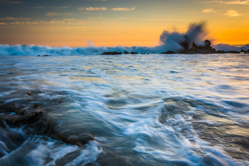 Rocks and waves in the Pacific Ocean at sunset, in Corona del Ma