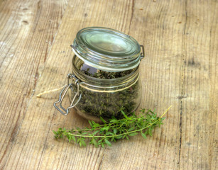Obraz na płótnie Canvas Dry Herbs in Glass Bottle