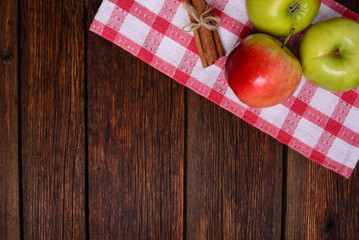 fresh apples with cinnamon on wooden table copy space