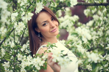 girl in flowers of apple tree