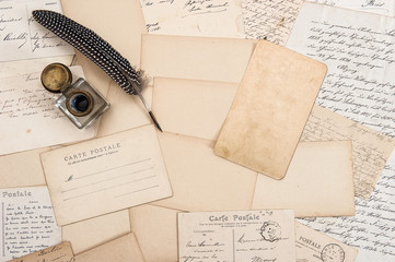 Old letters, vintage postcards and antique feather pen. Mock up