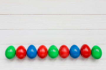 Easter eggs on white wooden background