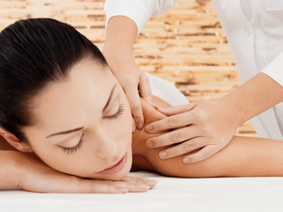 Fototapeta na wymiar Woman having massage of body in spa salon