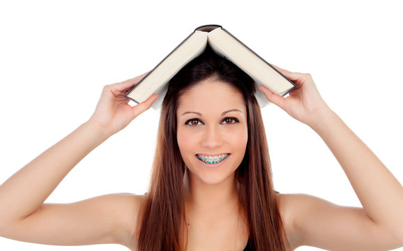 Attractive student woman with brackets an a book on the head