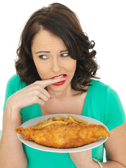 Young Woman Eating Traditional Fish and Chips