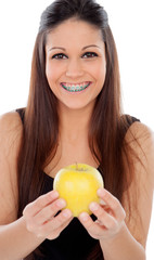 Attractive young woman with brackets eating a apple