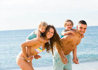 Fototapeta premium Family of four at the beach