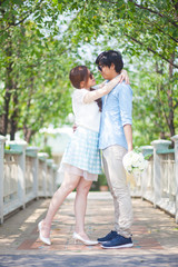 Fototapeta premium Loving asian couple under tree