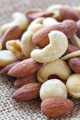 Fototapeta premium Close - up Mix of nuts on brown canvas backgrounf..