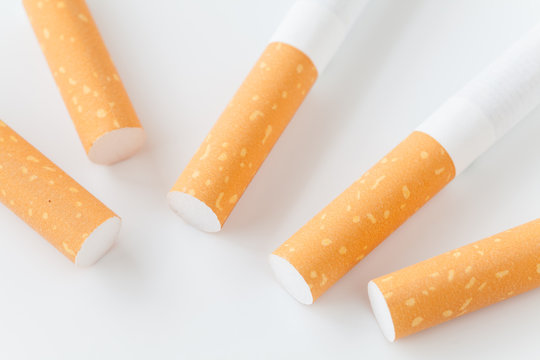 Close - up Row of Cigarette on white background .