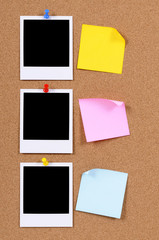 Fototapeta premium Vertical row or line of polaroid style blank photo frame print with post it sticky note pinned to cork notice board background