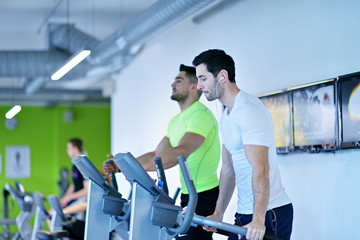 Group of people running on treadmills