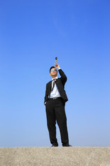 Businessman with telescope looking forward