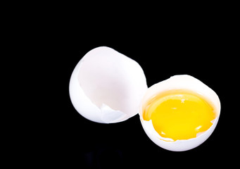 broken egg on a black background