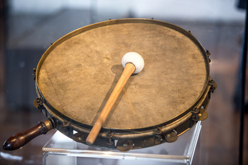 Closeup shot of old war tambourine with drumstick