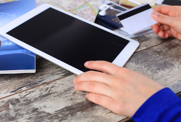Cropped image of woman using credit card and touchpad