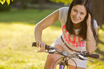 Fototapeta premium Young girl on a bicycle