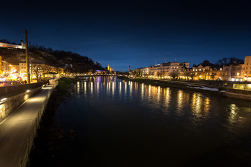 Fototapeta na wymiar view from bridge on river Salzach at Salzburg at night