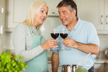 Happy mature couple making dinner together