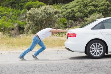 Man pushing his car