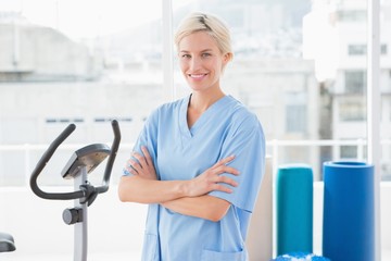 Smiling therapist with arms crossed