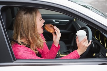 Young woman having coffee and doughnut