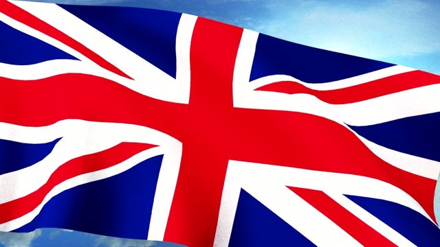 UK Britain Union Jack Flag Closeup Waving Against Blue Sky Seaml