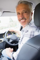 Man smiling while driving