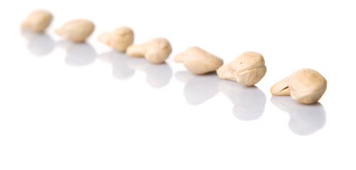Raw cashew nuts over white background
