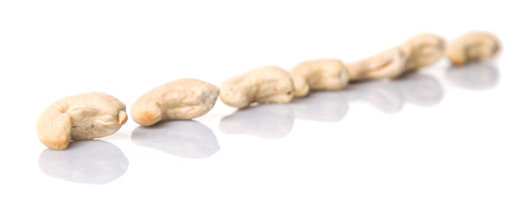 Raw cashew nuts over white background