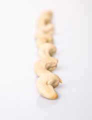Fototapeta na wymiar Raw cashew nuts over white background