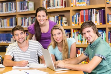 Fototapeta na wymiar College students doing homework in library