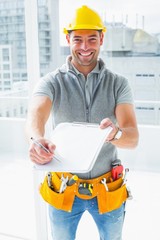 Happy manual worker giving clipboard for signature