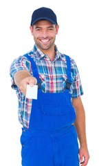 Portrait of happy handyman giving visiting card