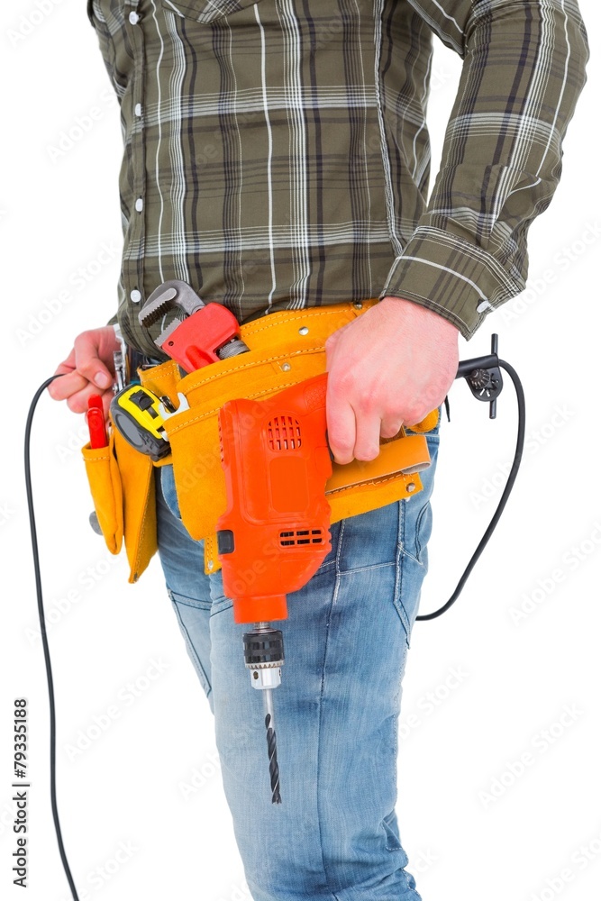 Poster smiling manual worker holding drill machine