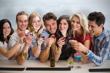 Composite image of friends with drinks