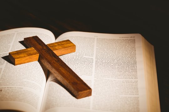 Open bible with crucifix icon