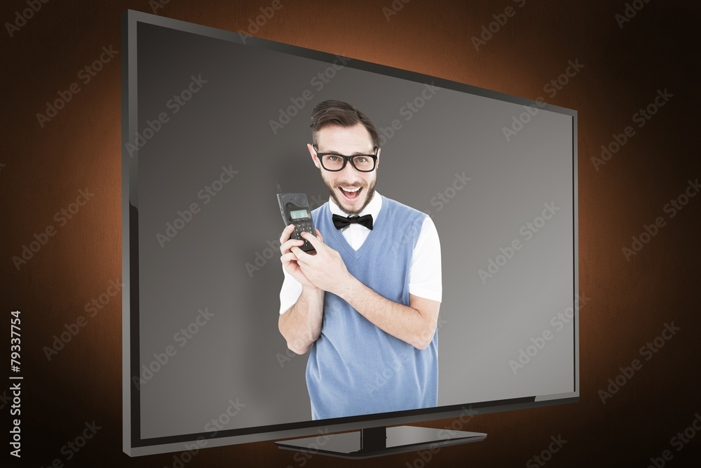 Aufkleber composite image of geeky hipster holding a retro cellphone