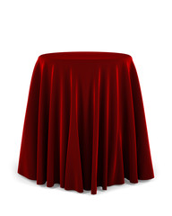 Round pedestal with red cloth over white background