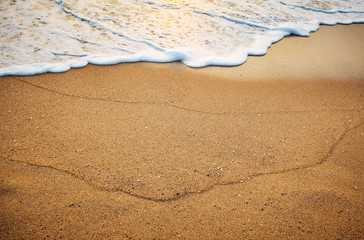 sand on the beach by the sea at sunrise