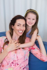 Mother and daughter smiling at camera