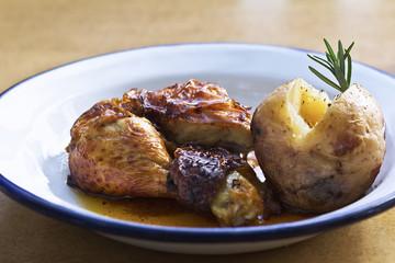 Roast chicken with potatoes on a plate