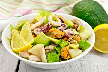 Salad seafood and lemon on white board
