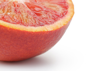 half of ripe blood red orange white background