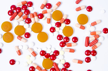 Many colorful pills isolated on white - obrazy, fototapety, plakaty