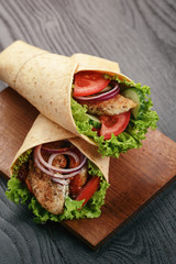 pair of fresh juicy tortilla wraps with chicken and vegetables